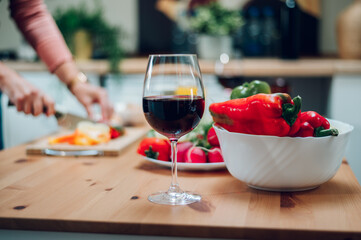 Red wine in a glass standing on a kitchen counter