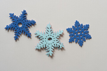 three piles of paper snowflakes