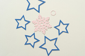 group of blue paper stars and single pink snowflake
