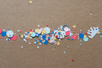 paper confetti or bits on brown cardboard