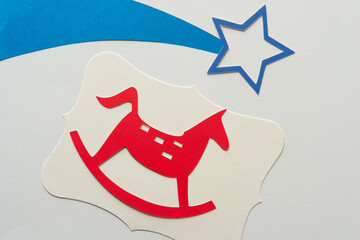 red paper hobby horse glyph or dingbat cutout and shooting blue paper stars
