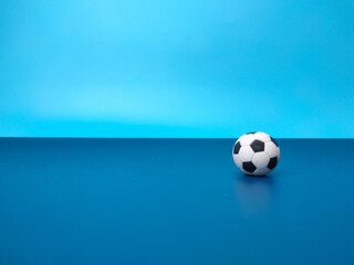 Fototapeta na wymiar A ball is on a blue background with copy space for text.