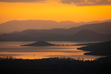 Obraz premium Lake Abaya and Nechisar National Park in Ethiopia at sunrise with layered mountains.
