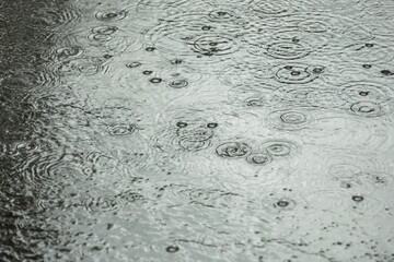 View of heavy pouring rain on city street