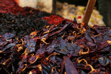 Heap of dried Serrano peppers on counter at market, closeup. Space for text