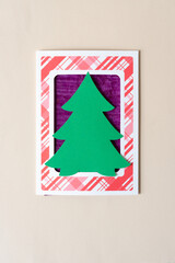simple holiday tree shape set inside a retro paper card