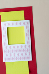 retro paper card with neon yellow, red, and beige paper background