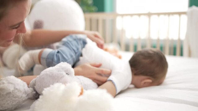 Mother and son playing on bed at bedroom
