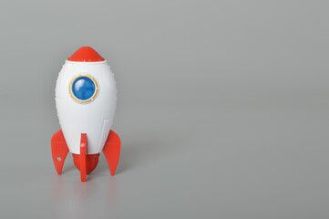 Toy rocket isolated on a grey background.The symbol for success is Start-up business, education and...