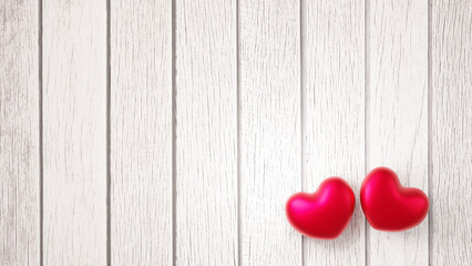 白い木の板の上に2つの赤色のハート。バレンタインやウェディングの背景素材。（横長）（俯瞰）