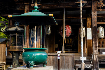 Pot with incense sticks burning at the buddhist shrine