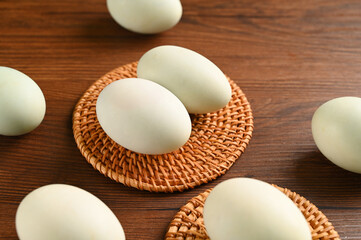 Close up colorful red yolk of salted duck eggs preserved in bamboo basket, asian style food