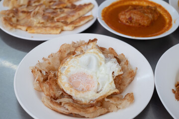 Fried Egg with Roti and Curry chicken, Thai spicy non-vegetarian food or recipe