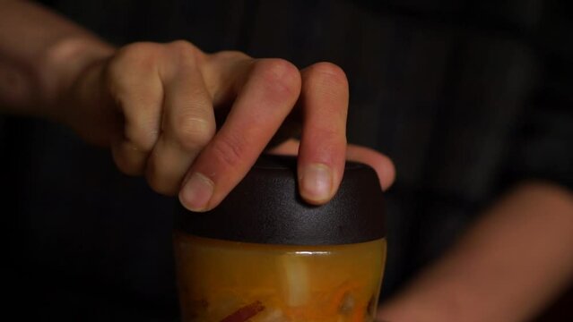 Horizontal video of a person closing a jar of fermented sauerkraut. Food.