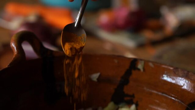 Spoon spices into a salad. Horizontal video of food.