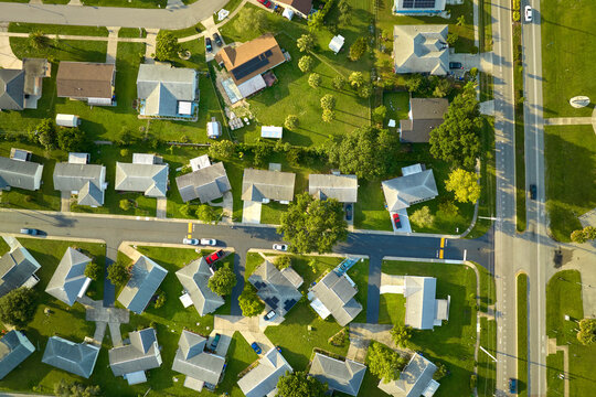 Aerial view of small town America suburban landscape with private homes between green palm trees in Florida quiet residential area