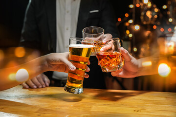 food and drink male friends are happy drinking beer and clinking glasses at a bar or pub. - obrazy, fototapety, plakaty