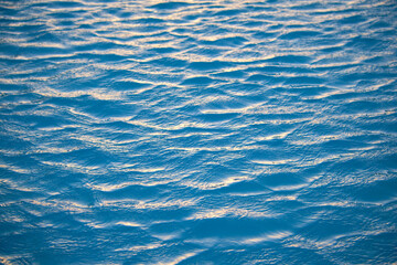 Closeup seascape surface of blue sea water with small ripple waves