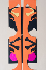 abstract paper shape (composed of stencil with skull and crossbones sliced in two)