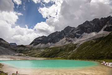 Obraz premium Milk Lake in Yading Nature reserve, Sichuan, China. Beautiful nature landscape. View from a viewpoint on top. Blue sky with copy space for text