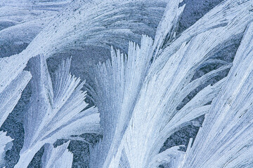 frost patterns on the window glass in cold winter day. natural icy texture.