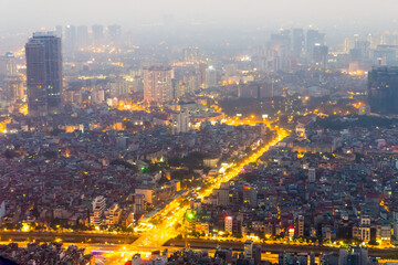 Aerial view of  car lights on a major arterial road through a large city at Hanoi in Vietnam