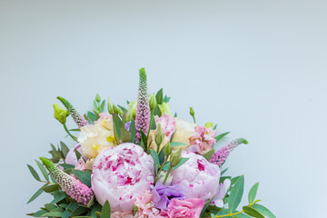 Rich bunch of pink peonies and lilac eustoma roses flowers, green leaf . Fresh spring bouquet. Holodays, gift.Arrangement of Beautiful blossoming flowers.wedding bouquet.copy space