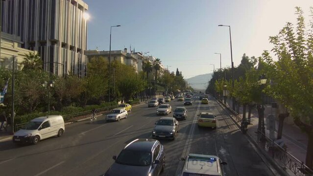 Flying trough the streets of Athens in Greece on top of a bus on a sunny day in autumn.	
