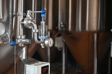 Photo of faucets and filter hoses at the beer production - 549363122