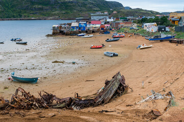 Houses and boats on shore of Barents Sea in Teriberka, Russia