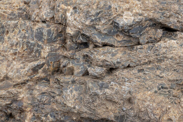 The texture of the surface of the stone, rocks. Brown background, wallpaper.