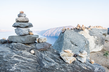 Stones tower with Oia and Santorini island on the background. 