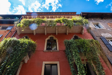 Low angle view of Verona red building balcony with plants