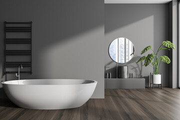 Fototapeta na wymiar Front view on dark bathroom interior with bathtub, round mirror