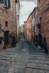 Obraz na płótnie Canvas Narrow alley with medieval rock buildings