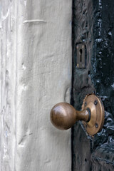 Old vintage brass door handle on wooden door