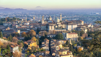Naklejka premium Bergamo. One of the beautiful city in Italy. Landscape at the old town from the hill during sunset. Amazing view of the towers, bell towers and main churches. Touristic destination. Best of Italy
