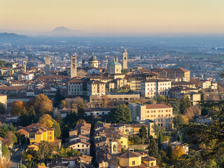 Fototapeta na wymiar Bergamo. One of the beautiful city in Italy. Landscape at the old town from the hill during sunset. Amazing view of the towers, bell towers and main churches. Touristic destination. Best of Italy