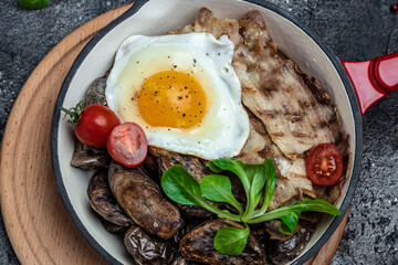 Baked sweet purple potatoes, grilled bacon and fried egg
