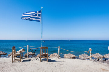 Greek flag and blue sky at a dock at Santorini island, Greece