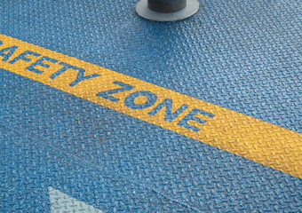 Blue Embossed metal sheet floor pattern surface with text , Safety Zone for preventing accidents on the port. - 549378538