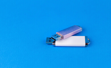 Two flash drives on a blue background