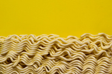 Uncooked instant noodles isolated on yellow background
