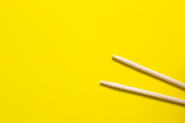 Bamboo chopsticks isolated on yellow background