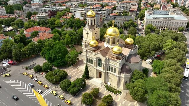 Cathedral in City center of Varna. Urban Landscape. Golden domes of the Assumption Cathedral. Aerial view. Drone flight around the Dormition of the Mother of God. Varna is the sea capital of Bulgaria.