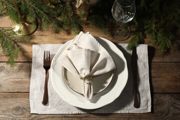 Stylish table setting with white fabric napkin, beautiful decorative ring and festive decor on...