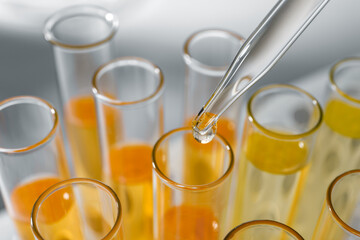 Dropping urine sample for analysis into tube, closeup