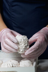 Homemade zephyr. Homemade marshmallows. A woman puts a ready-made zephyr on a tray.