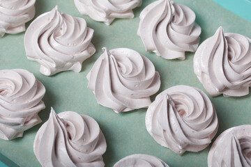 Homemade zephyr. White tray with marshmallows. Stands on black pine boards. Close-up.
