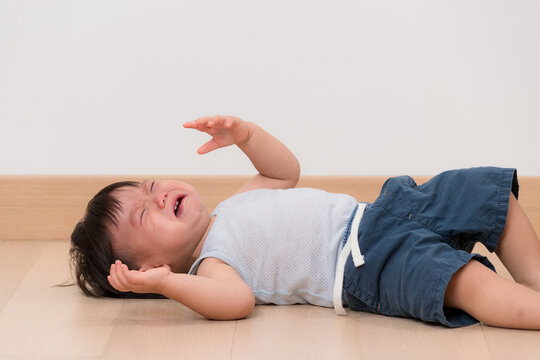 Asian cute baby boy cry and lying down on floor